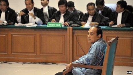 Former chief of the Indonesian police traffic division Djoko Susilo (R) backed by a panel of defence lawyers, listens during the indictment proceeding by the anti-graft court in Jakarta on 23 April 2013 to face trial for corruption charges