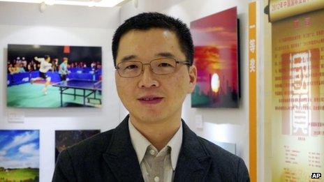 File photo: Yu Qiyi poses for a photo at an exhibition held at a hotel in Beijing, 2 September 2012