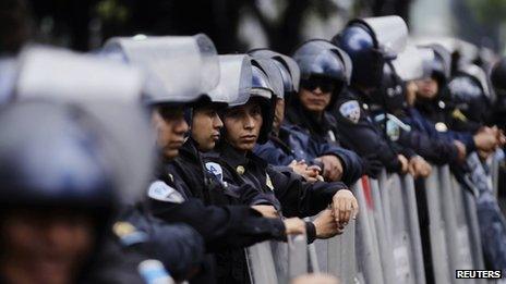 Riot police stand guard outside the Mexican Senate on 3 September 2013