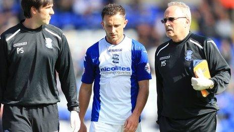 Neal Eardley leaves the pitch after suffering his knee injury against Ipswich