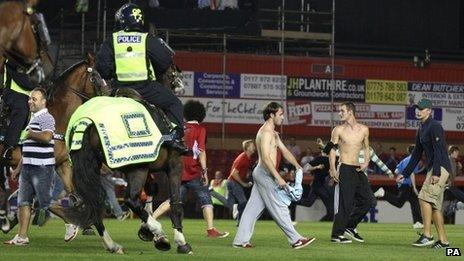 Riot Police on horseback clear the pitch at Ashton Gate