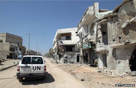 A UN vehicle drives through Homs in 2012