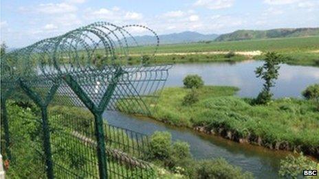 Razor wire delineates the border between North Korea and China