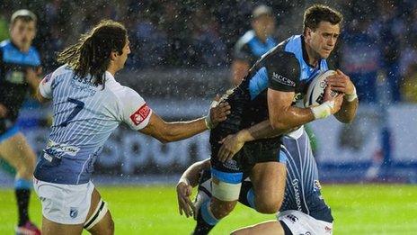 Glasgow Warriors' Alex Dunbar is tackled by Cardiff duo Josh Navidi and Gavin Evans