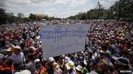 A supporter of the Cambodia National Rescue Party (CNRP) holds a banner during a rally in Phnom Penh, Cambodia, 7 September 2013