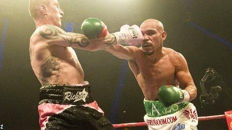 Ricky Burns (left) lands a punch against Raymundo Beltran