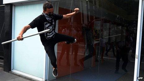 Sao Paulo activists breaks bank window