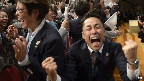 Tokyo 2020 delegation members celebrate after IOC president Jacques Rogge announced the Japanese capital to be the winner of the bid to host the 2020 Summer Olympic Games