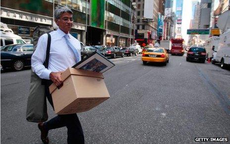 Lehman employees carries a box of belongings