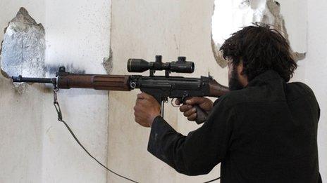 A Free Syrian Army fighter stands in a shooting position in Raqqa province, eastern Syria on 8 September 2013