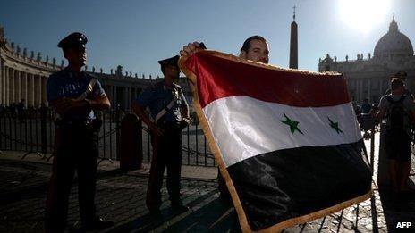 A man with a Syrian flag arrives in St Peter's Square at the Vatican on 7 September 2013