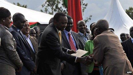 Kenya's President, Uhuru Kenyatta, and his deputy, William Ruto, hand out cheques on September 7, 2013 at Eldoret in Kenya's North-Rift