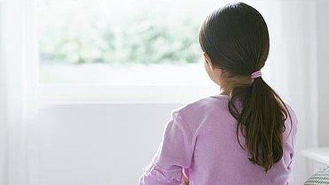 young girl at window