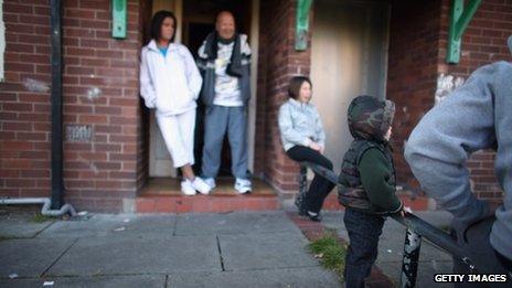 Family outside council home in Salford