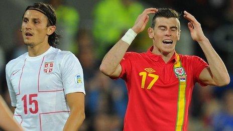 Gareth Bale holds his head in despair after missing a chance against Serbia