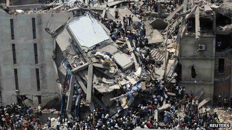 People try to rescue garment workers trapped under the rubble of the collapsed Rana Plaza building