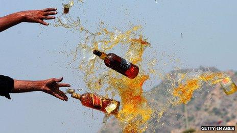 Pakistani Frontier Corps (FC) personal brake liquor bottles in a ceremony in the Shahkas area of the Jamrud Khyber Agency, one of the Federally Administered Tribal Areas, on 26 June 2013. Officials destroyed the contraband as part of International Anti-drug Day.