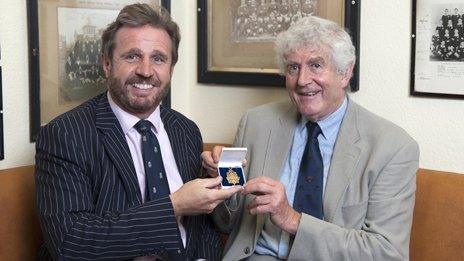 Richard Madley, of auctioneers Dreweatts & Bloomsbury, and Welsh Sports Hall of Fame chairman Rhodri Morgan hold the medal