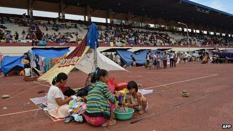 Residents living along the coast near the area of a stand-off between the Philippine military and Muslim gunmen take shelter at a sports complex used as a temporary evacuation centre in Zamboanga on the southern Philippine island of Mindanao on 11 September 2013