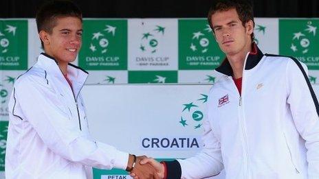 Andy Murray of Great Britain shakes hands with first day opponent Borna Coric of Croatia during previews ahead of the Davis Cup World Group play-off tie between Croatia and Great Britain