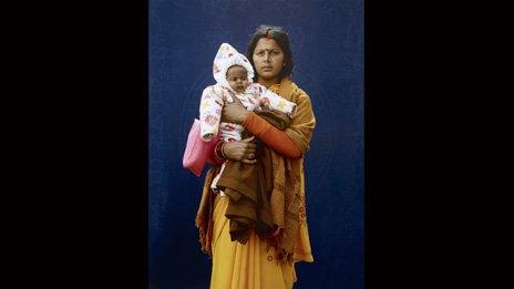 Kumbh Mela Pilgrim - Mamta Dubey and infant by Giles Price