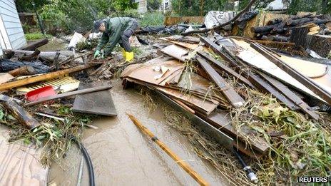 A man (requested his name not be used) tries to untangle debris that have been washed down to his home after severe flooding in Boulder, Colorado 12 September 2013