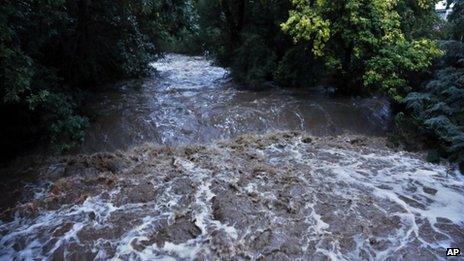 High water levels flow down Boulder Creek following overnight flash flooding in downtown Boulder, Colorado 12 September 2013