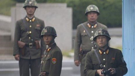 North Korean soldiers watch south at the truce village of Panmunjom in the demilitarized zone separating North Korea from South Korea, north of Seoul, 11 September 2013