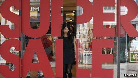 A woman leaves a shopping mall in central Seoul 31 July 2013