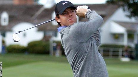 Rory McIlroy watches his shot at the third hole on Friday