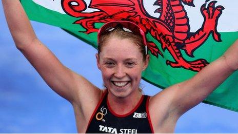 Non Stanford waves a Welsh flag after crossing the line to win the ITU world series triathlon in London