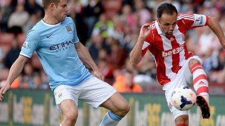 Manchester City's James Milner thwarts Stoke City's Matthew Etherington