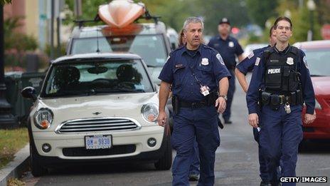 Police officers walk on a street near the navy yard