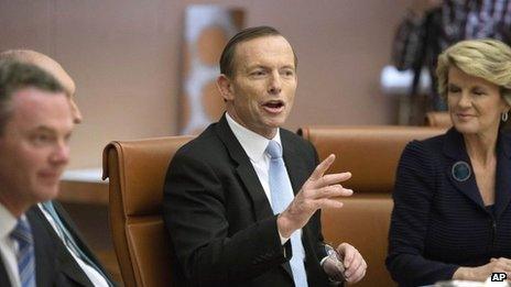 Australia's new Prime Minister Tony Abbott, centre, leads the first meeting of his full ministry in the Cabinet Room of Parliament House