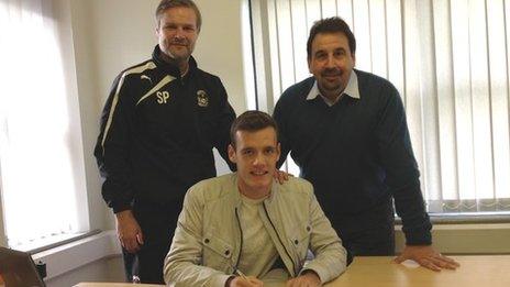 Stuart Urqhart signs for Coventry, watched by boss Steven Pressley and development director Steve Waggott