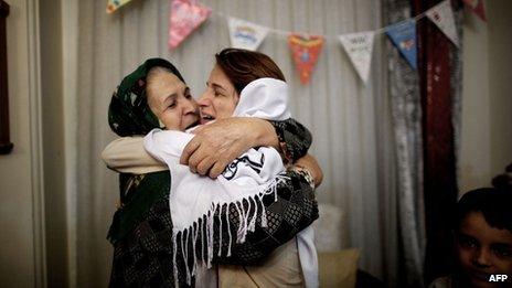 Iranian lawyer Nasrin Sotoudeh (R) hugs her mother-in-law at her house in Tehran following being freed after three years in prison