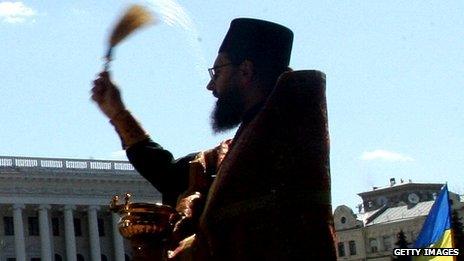 A Ukrainian priest performs a blessing