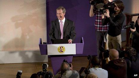 Nigel Farage laughing in front of photographers and TV cameras