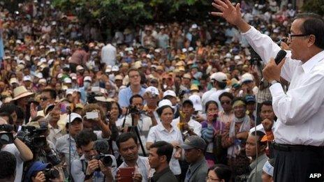 Leader of the opposition Cambodia National Rescue Party (CNRP) Sam Rainsy (R) speaks to supporters during a demonstration at the Democracy Park in Phnom Penh on 17 September 2013