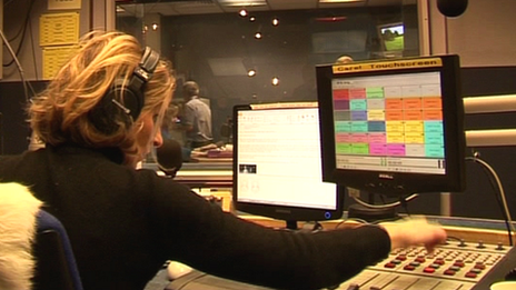 A radio presenter at her console