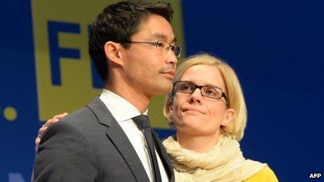 German free democratic party FDP party chairman Philipp Roesler (L) is comforted by his wife Wiebke