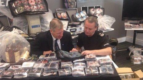 Kenny MacAskill viewing counterfeit goods