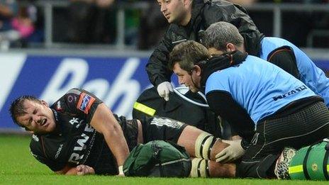 Tom Smith getting treatment for a suspected dislocated knee