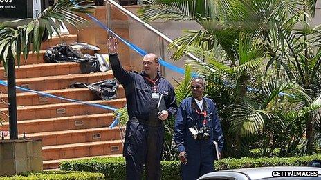 A Kenyan forensics expert alongside a foreign colleague