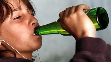 Nine-year-old boy drinking (model)