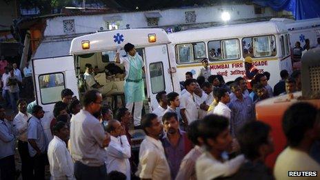 A paramedic looks out from an ambulance as rescue operations continue for survivors at the site of a collapsed residential building in Mumbai.