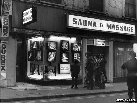 Men clustered outside a Soho sauna and massage parlour, 1973