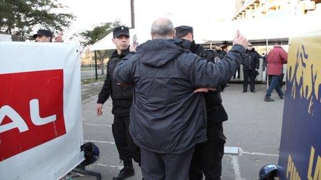 A man is searched at the entrance to the Bombonera stadium