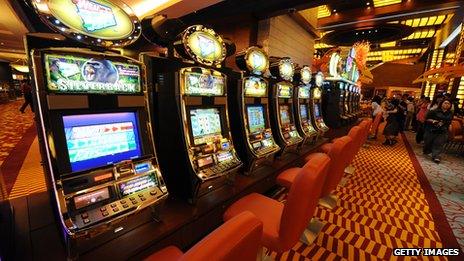 A row of gambling machines in Singapore's first casino that opened in 2010