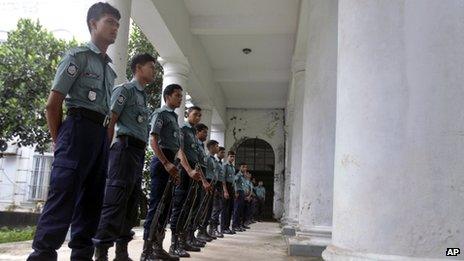 Police stand guard outside the tribunal in Dhaka on 1 October